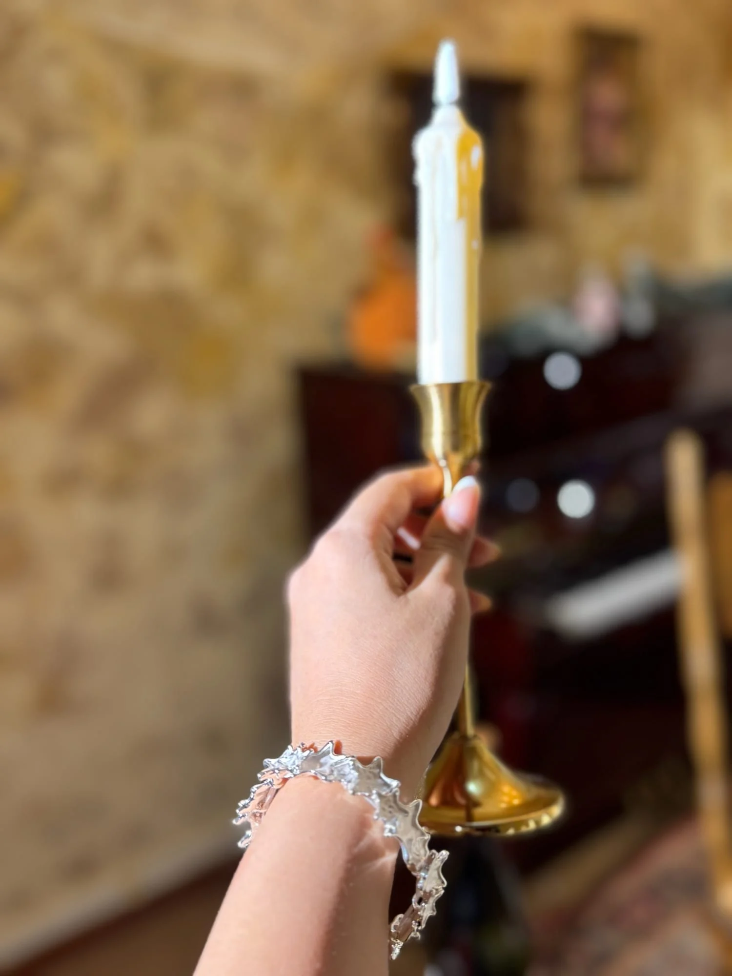A second candlestick photograph of the same silver-toned star bangle.